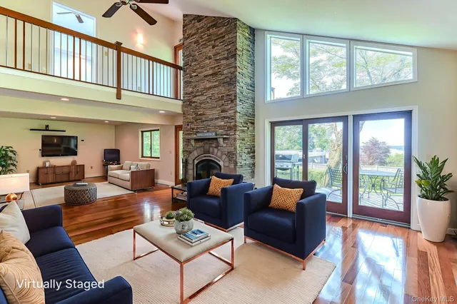 a living room with furniture fireplace and a table