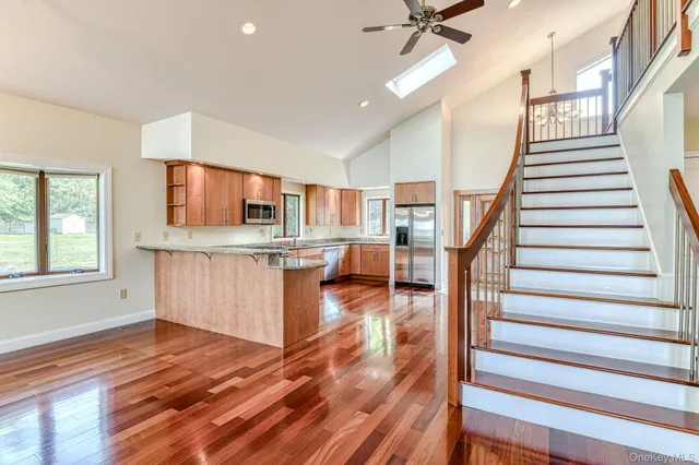 a view of kitchen and hall with wooden floor