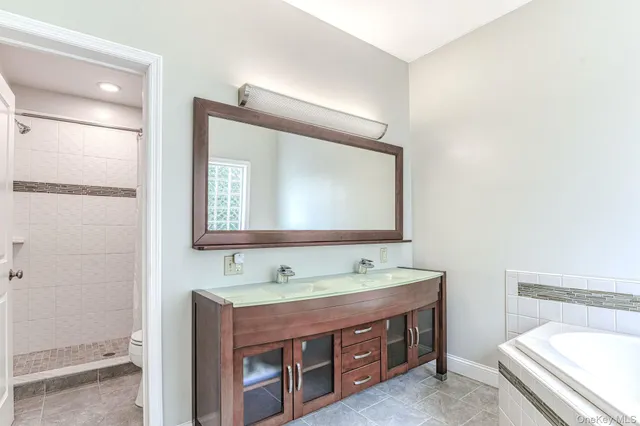 a bathroom with a double vanity sink and a mirror