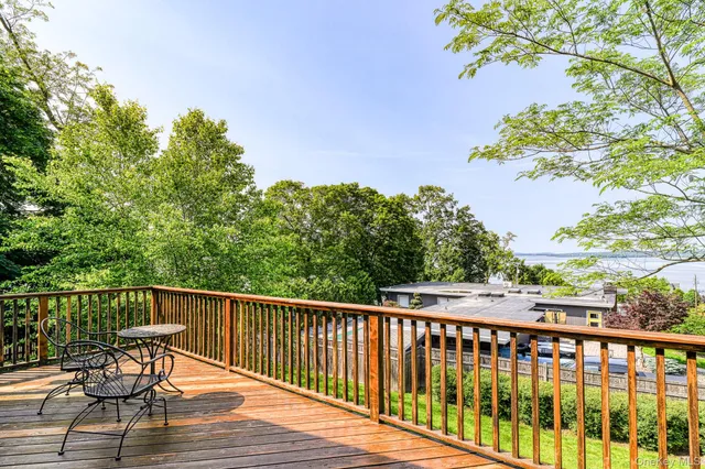 a view of a balcony with wooden floor and fence