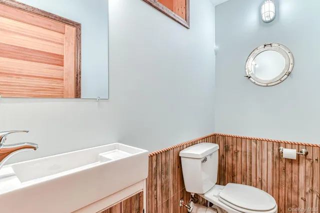a white toilet sitting next to a bathroom sink
