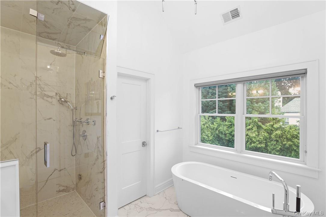 113 Brown Road Scarsdale, NY 10583 - Photo 12 of 27 a bathroom with a bathtub shower and window