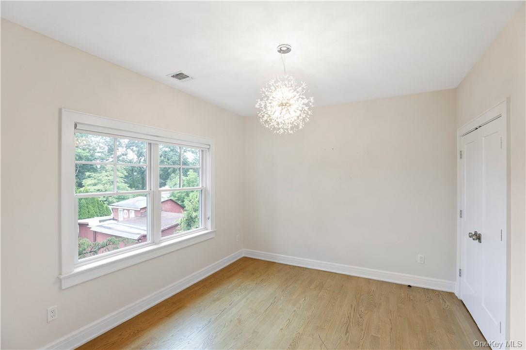 113 Brown Road Scarsdale, NY 10583 - Photo 15 of 27 a view of room with window and hardwood floor