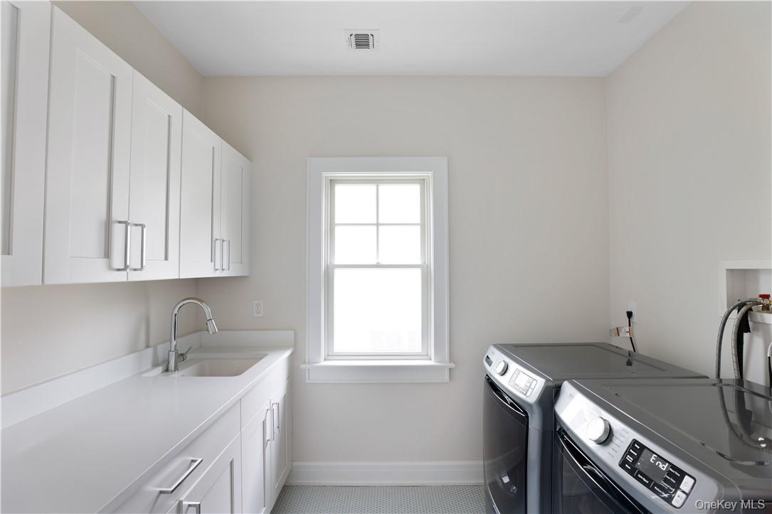 113 Brown Road Scarsdale, NY 10583 - Photo 18 of 27 a utility room with a sink dryer and washer