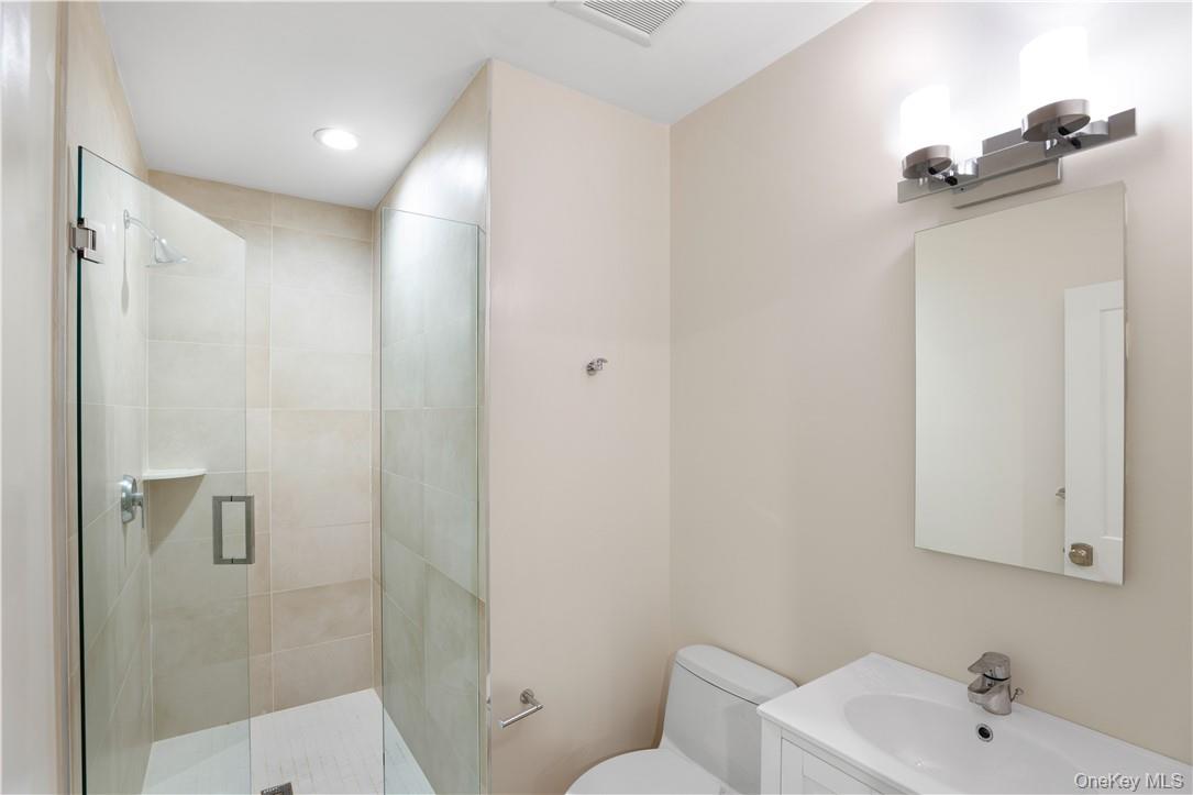 113 Brown Road Scarsdale, NY 10583 - Photo 23 of 27 a bathroom with a sink and mirror