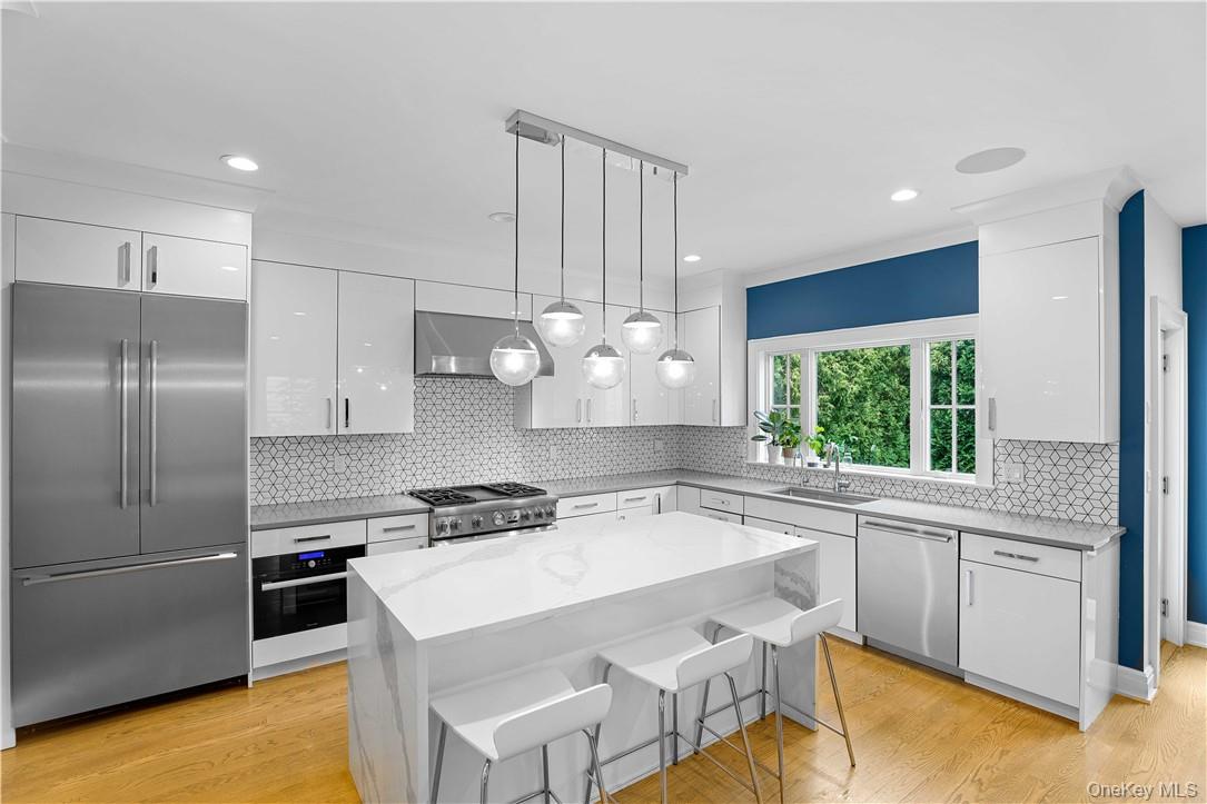 113 Brown Road Scarsdale, NY 10583 - Photo 3 of 27 a kitchen with a stove a refrigerator and a sink
