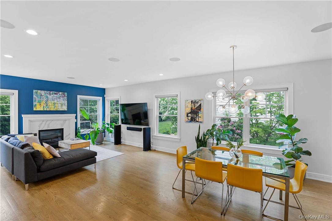 113 Brown Road Scarsdale, NY 10583 - Photo 5 of 27 a living room with furniture a chandelier and a fireplace