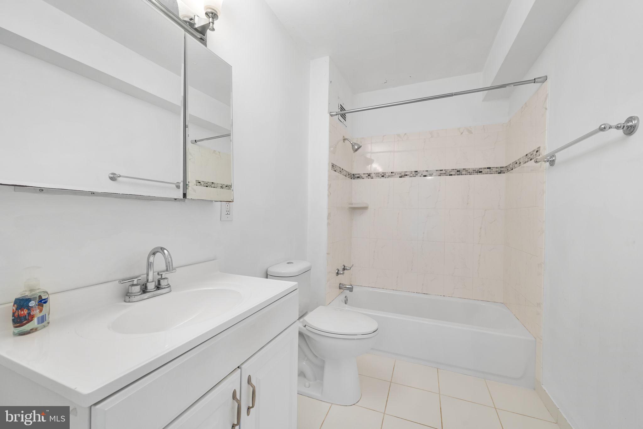 4301 Massachusetts Avenue Northwest, Unit 6006 Washington, DC 20016 - Photo 13 of 33 a bathroom with a sink a toilet and shower