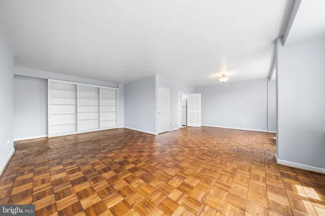a view of empty room with wooden floor