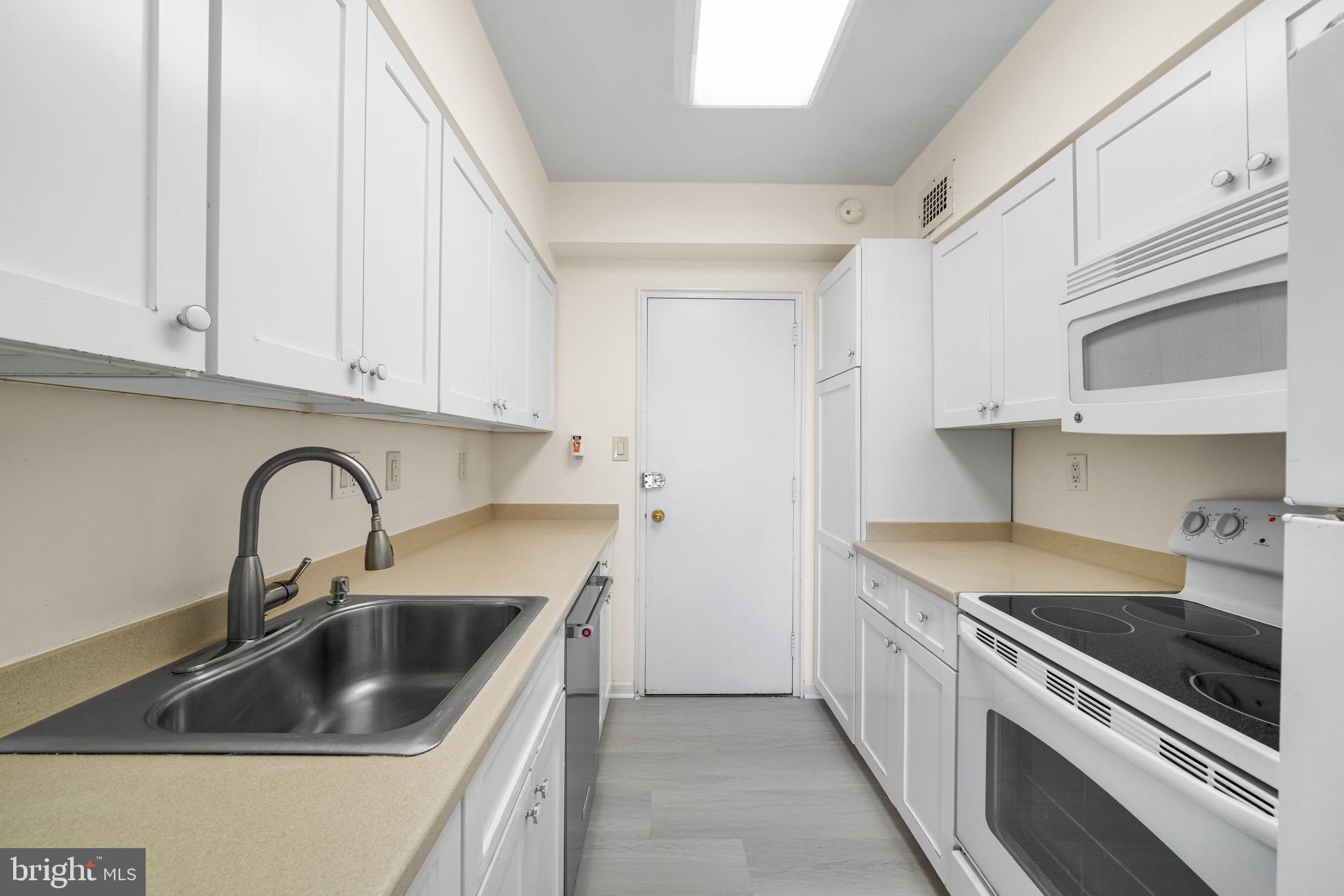 4301 Massachusetts Avenue Northwest, Unit 6006 Washington, DC 20016 - Photo 24 of 33 a kitchen with stainless steel appliances granite countertop a sink stove and cabinets