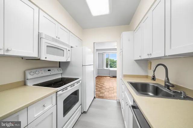 a kitchen with stainless steel appliances granite countertop a sink and a stove