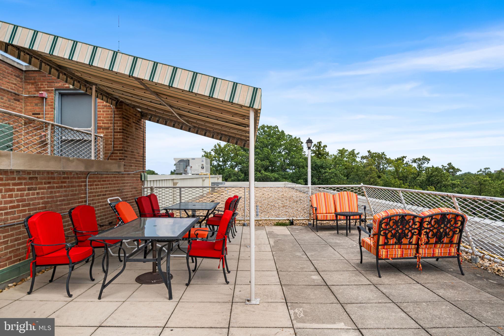 4301 Massachusetts Avenue Northwest, Unit 6006 Washington, DC 20016 - Photo 31 of 33 a view of deck with table and chairs with wooden floor and fence
