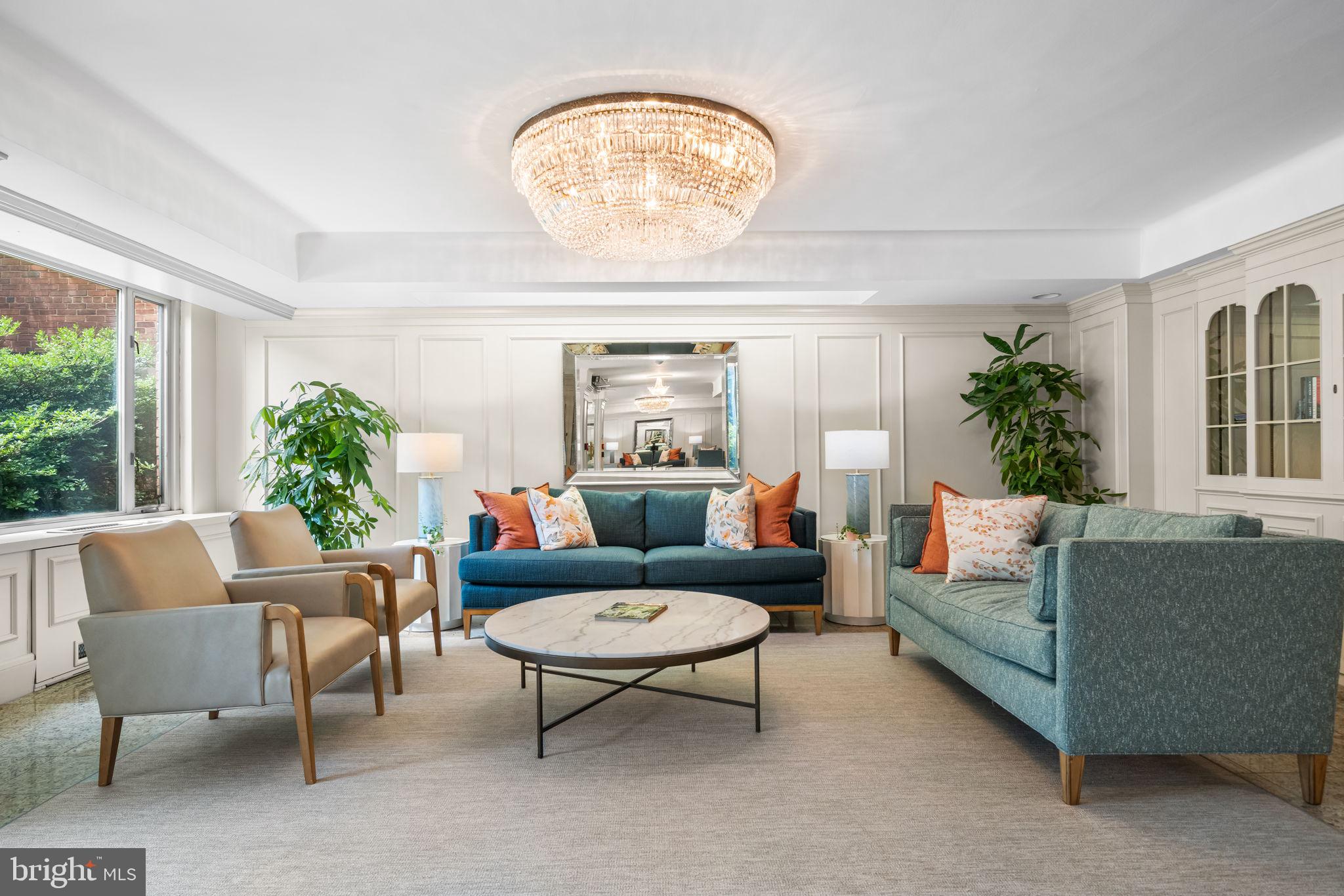 4301 Massachusetts Avenue Northwest, Unit 6006 Washington, DC 20016 - Photo 33 of 33 a living room with furniture a chandelier and a window