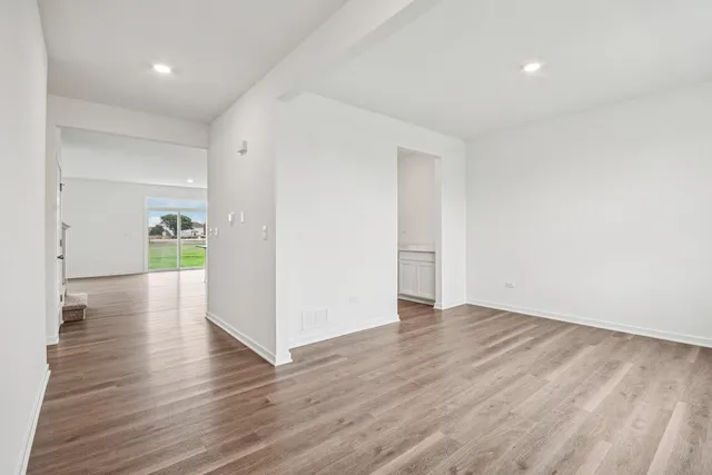 a view of a hallway with wooden floor