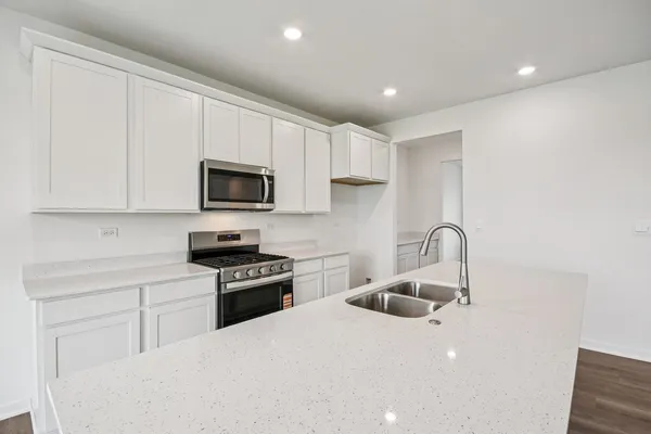 a kitchen with sink a microwave and stove