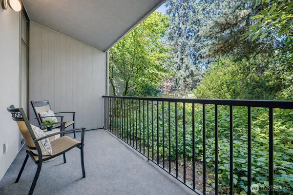 a view of a chair and table in the balcony