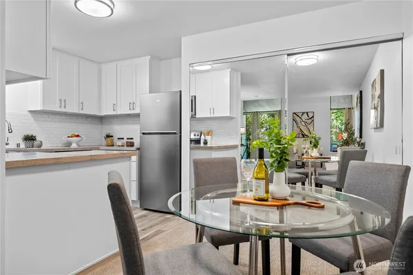 a kitchen with a dining table and chairs