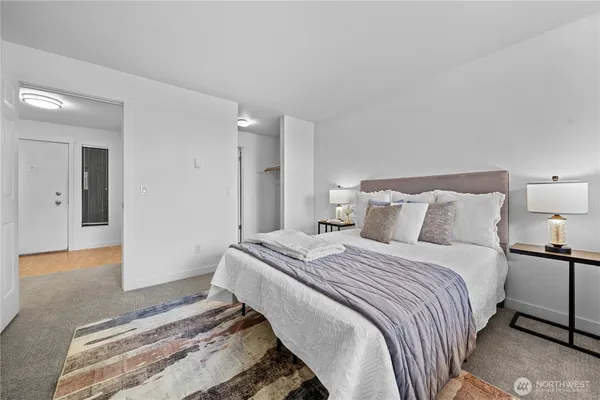 a bedroom with bed and a night stand