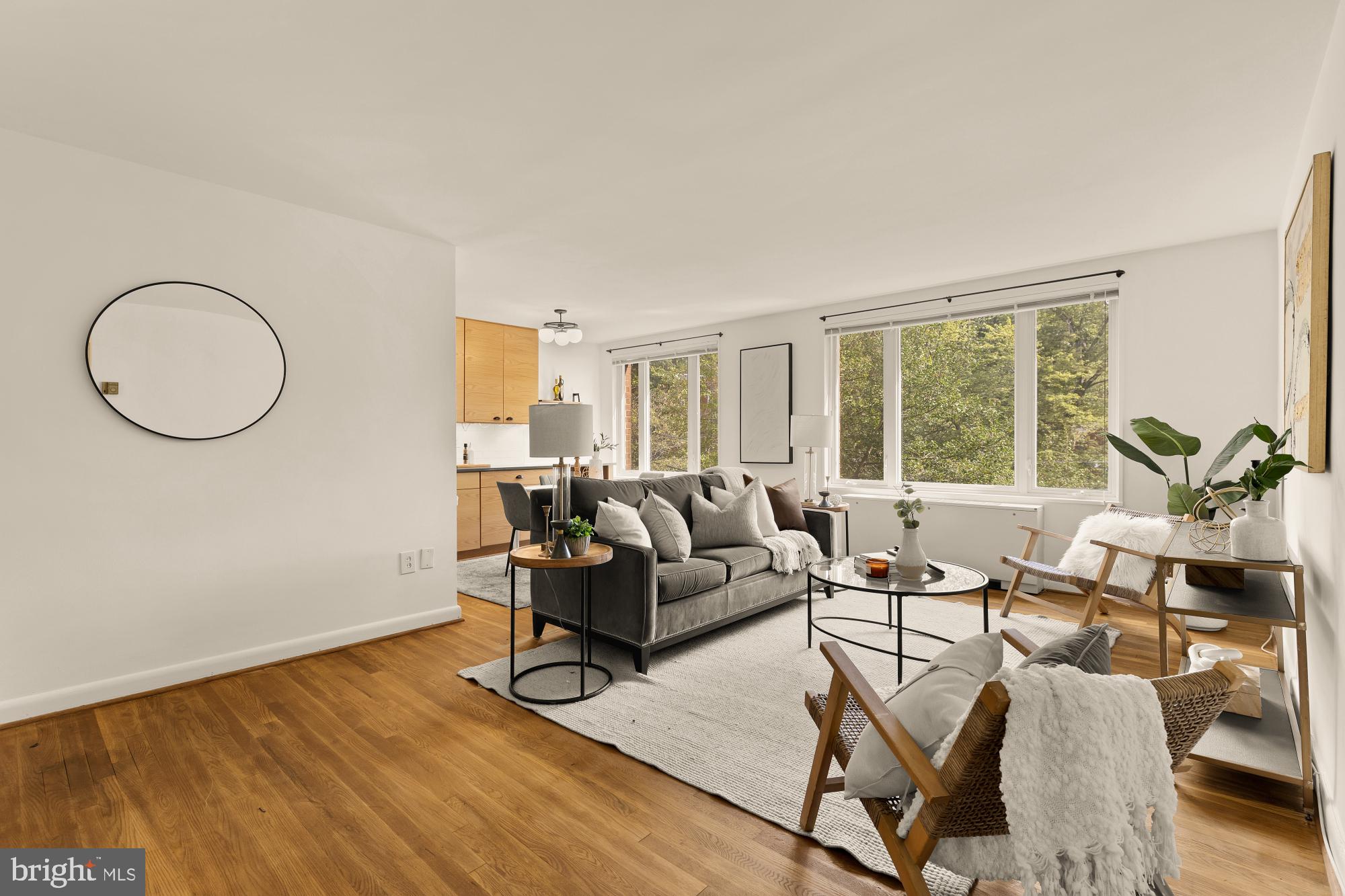 a living room with furniture and floor to ceiling window