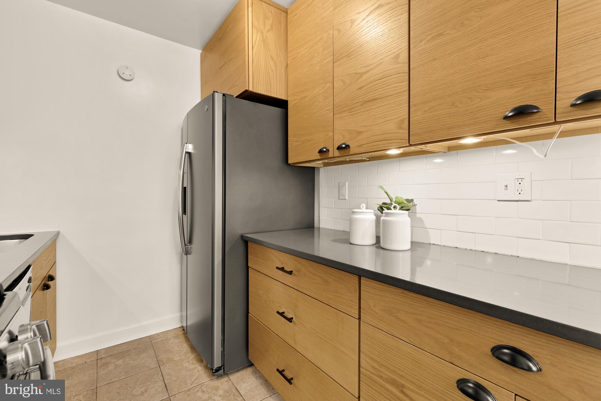 2400 41st Street Northwest, Unit 502 Washington, DC 20007 - Photo 15 of 25 a kitchen with stainless steel appliances a refrigerator and cabinets