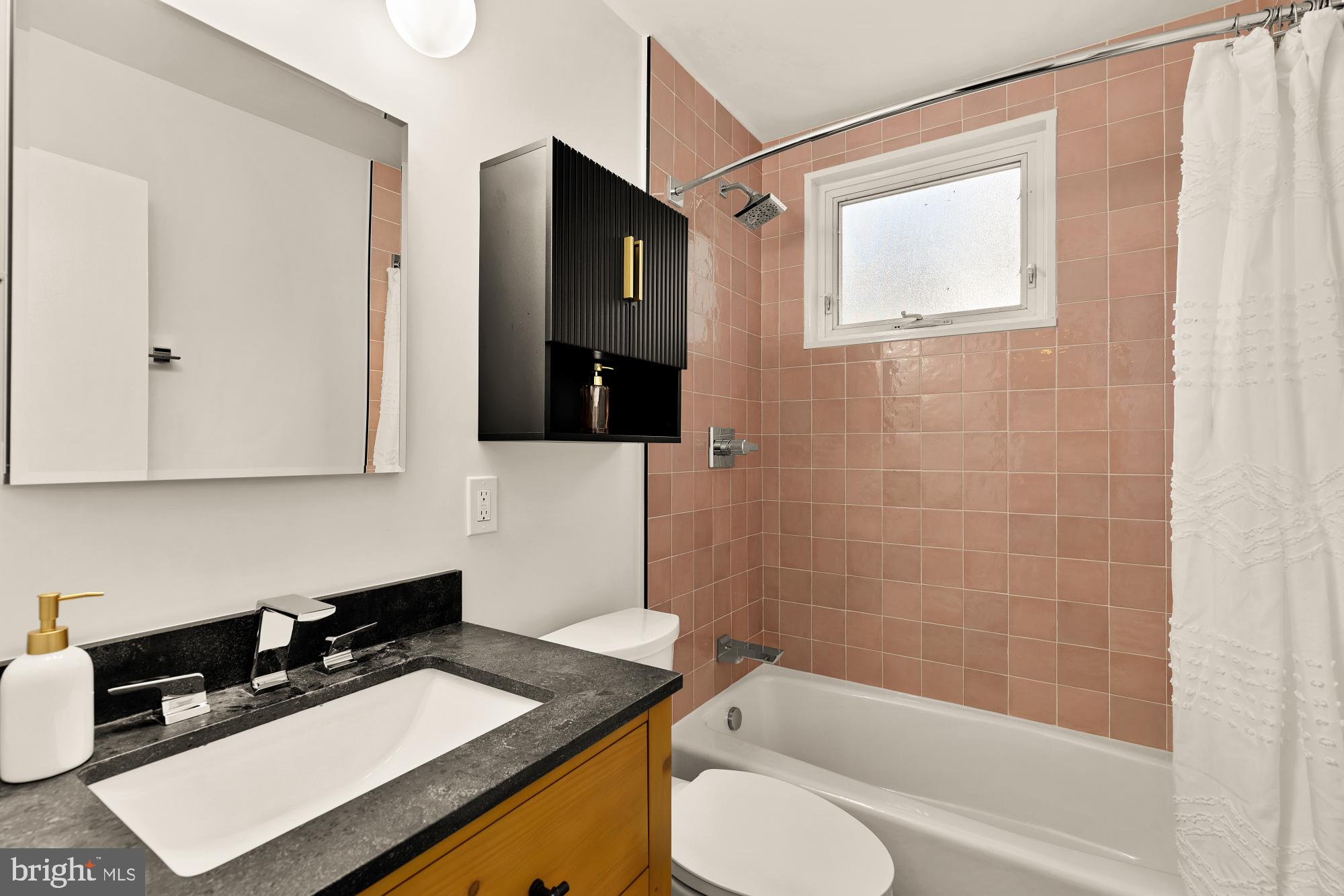 2400 41st Street Northwest, Unit 502 Washington, DC 20007 - Photo 16 of 25 a bathroom with a sink a toilet and shower