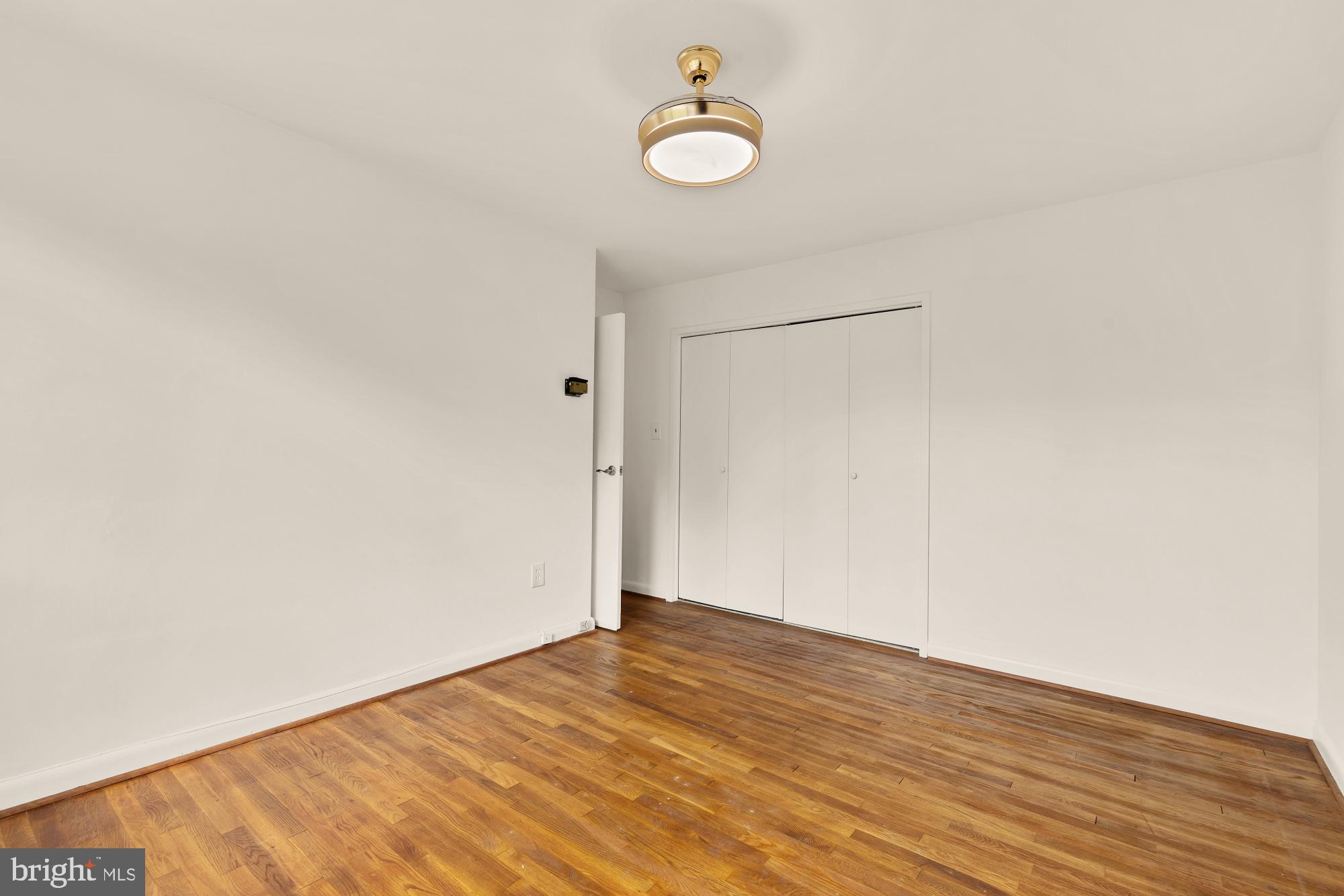 2400 41st Street Northwest, Unit 502 Washington, DC 20007 - Photo 18 of 25 a view of a room with wooden floor and white walls