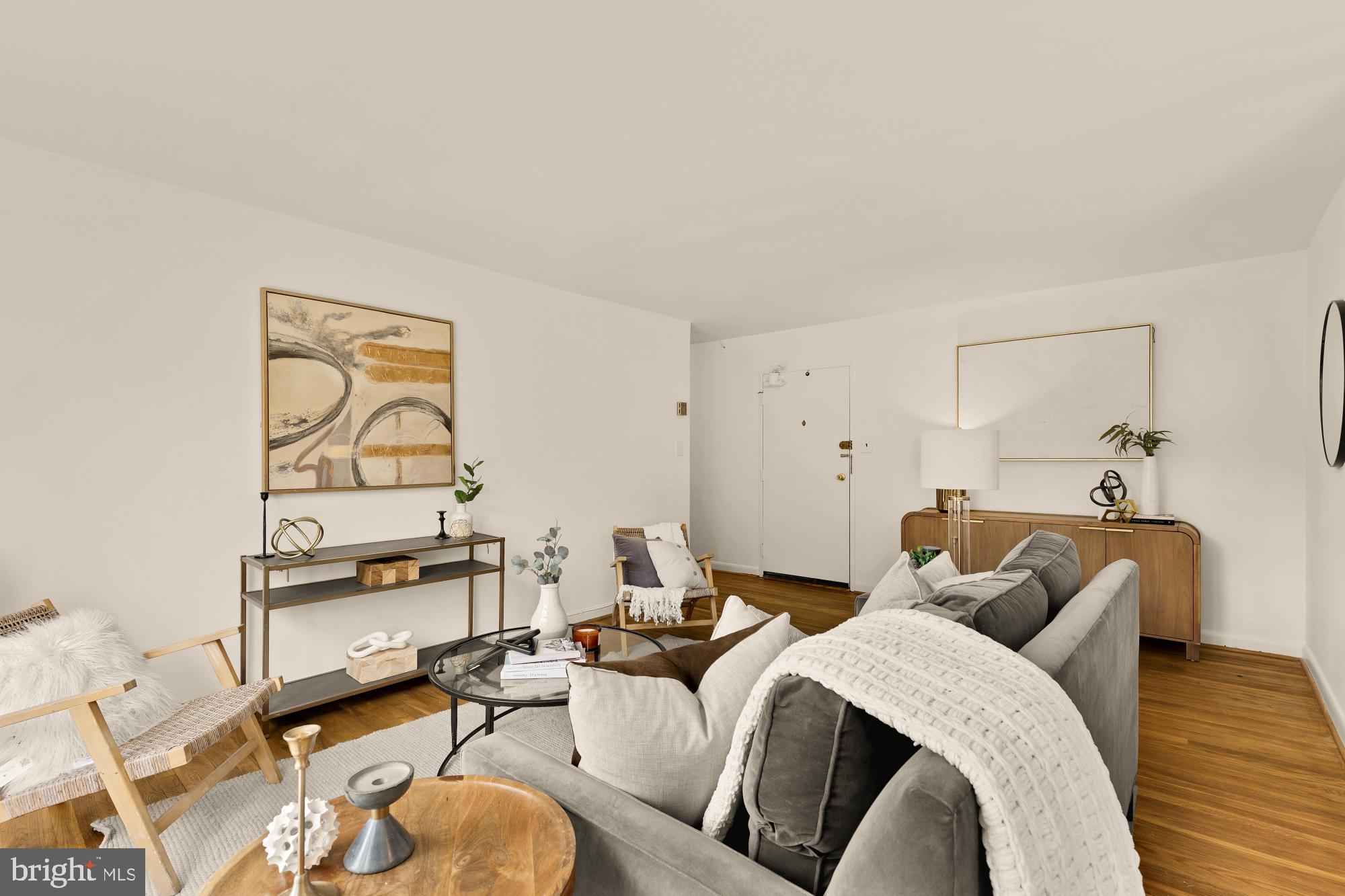 2400 41st Street Northwest, Unit 502 Washington, DC 20007 - Photo 4 of 25 a living room with furniture a rug and white walls