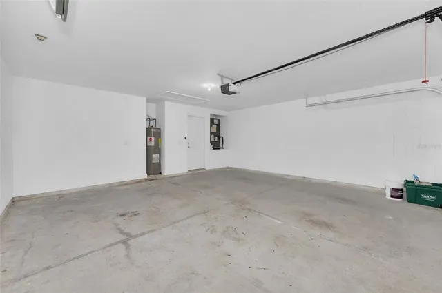 a view of an empty room with a fireplace and a window