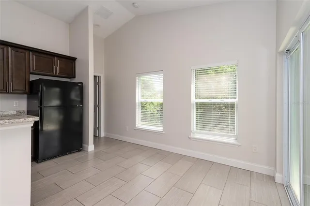 a view of a porch with a floor to ceiling window and garden