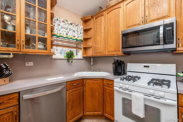 a kitchen with stainless steel appliances granite countertop a sink and a microwave