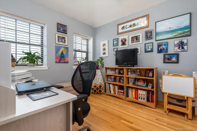 a view of a workspace with furniture and a bookshelf