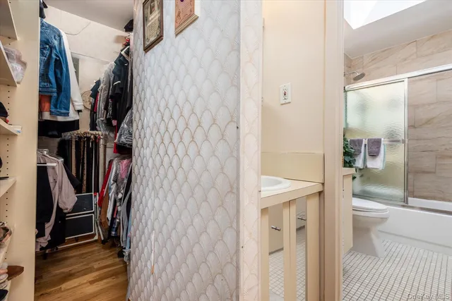 a bathroom with a shower toilet and sink
