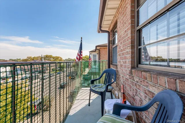 a view of a chairs and table in the balcony