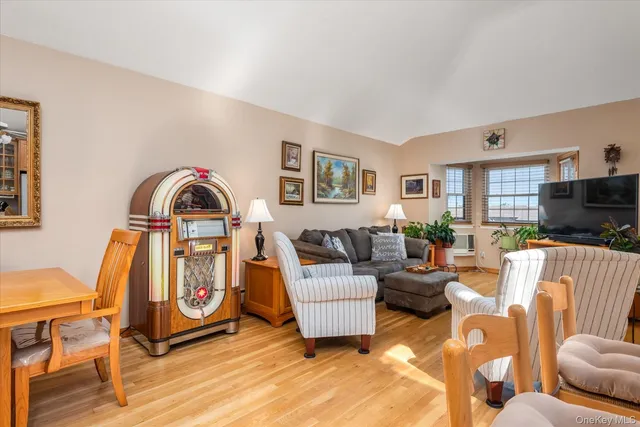 a living room with furniture a couch and a flat screen tv