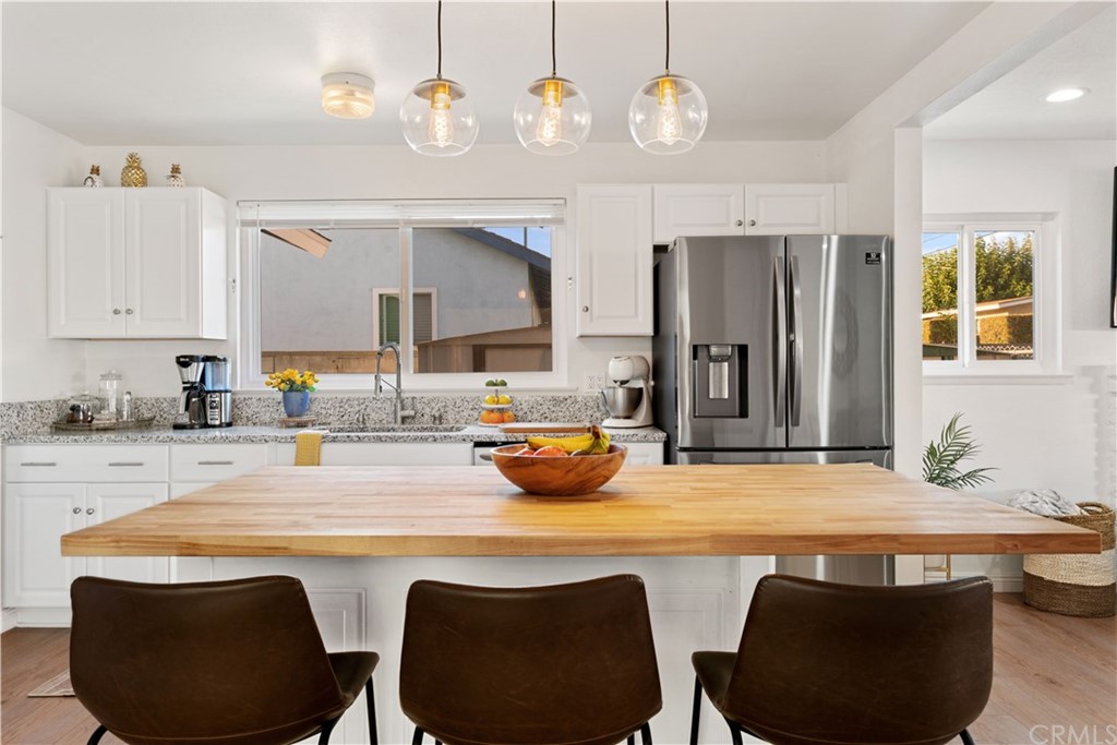 4902 McCormack Lane Placentia, CA 92870 - Photo 1 of 16 a kitchen with kitchen island a dining table and chairs