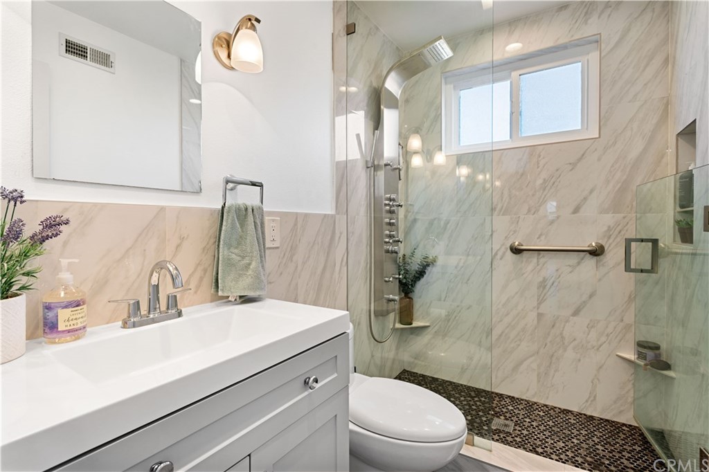 4902 McCormack Lane Placentia, CA 92870 - Photo 14 of 16 a bathroom with a sink a toilet a mirror and shower
