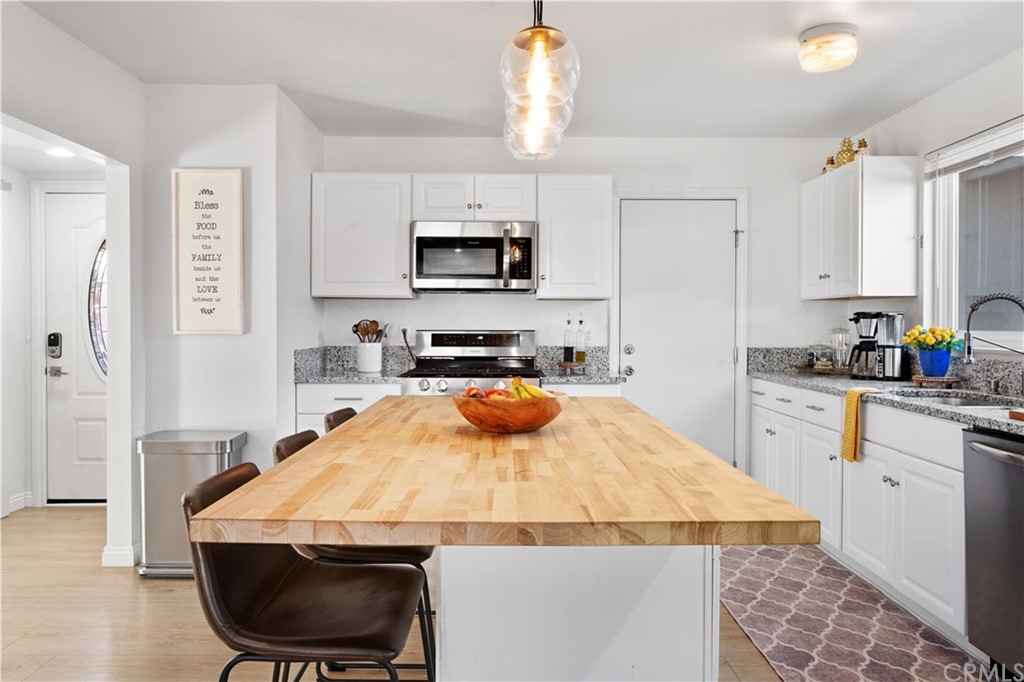 4902 McCormack Lane Placentia, CA 92870 - Photo 7 of 16 a kitchen with stainless steel appliances a stove a sink and a refrigerator