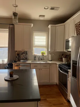 a kitchen with sink cabinets and window