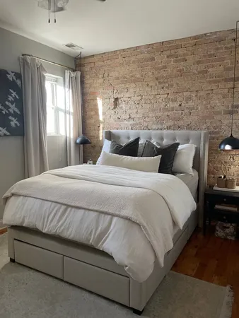 a bedroom with a bed and window