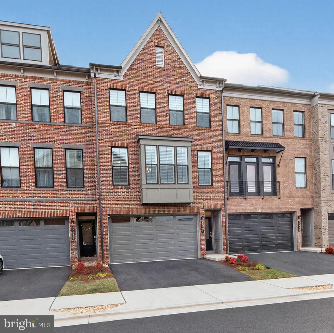5241 Ridgeview Retreat Drive Chantilly, VA 20151 - Photo 1 of 32 a front view of a residential apartment building with a yard