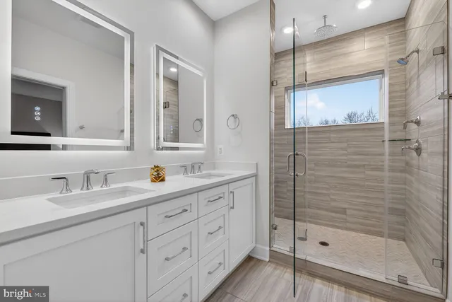 a bathroom with a shower sink and mirror