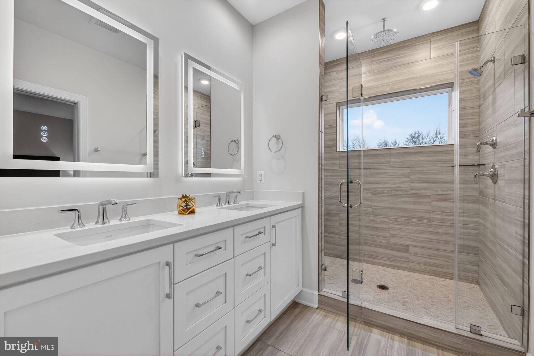 5241 Ridgeview Retreat Drive Chantilly, VA 20151 - Photo 7 of 32 a bathroom with a shower sink and mirror