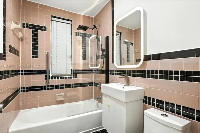 a bathroom with a bathtub a sink and a large mirror