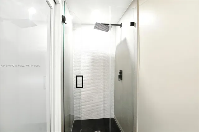 a bathroom with a shower and a mirror