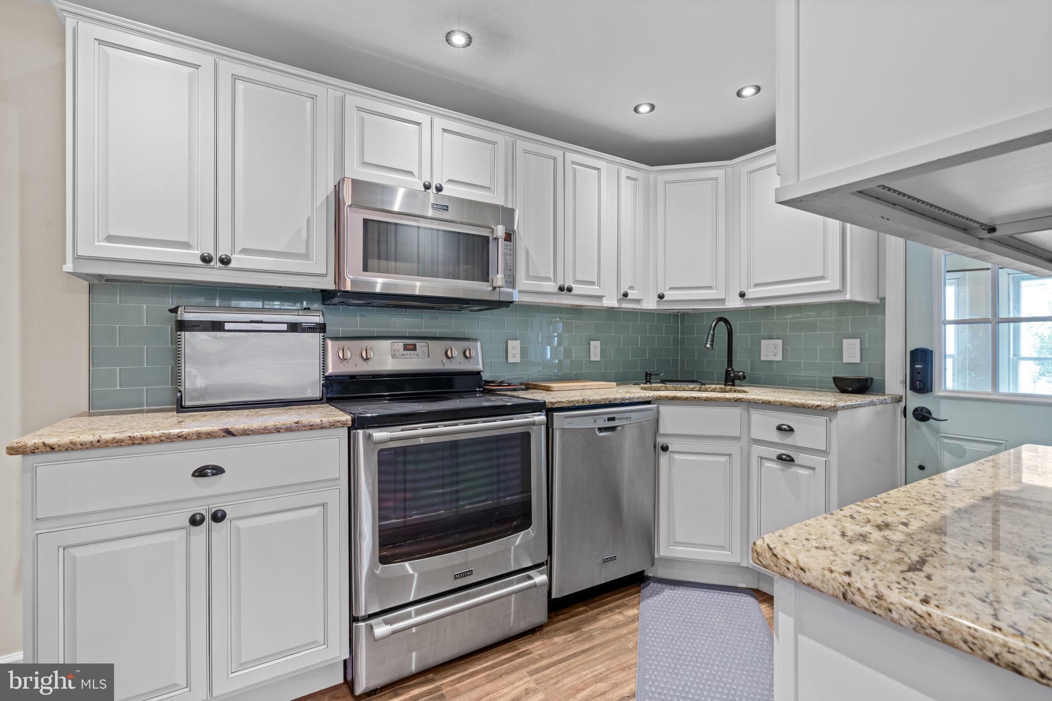 4009 Redden Road Drexel Hill, PA 19026 - Photo 8 of 21 a kitchen with white cabinets stainless steel appliances and sink