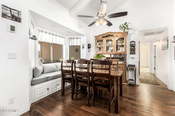 a view of a a dining room with furniture window and wooden floor