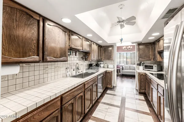 a kitchen with stainless steel appliances kitchen island granite countertop a sink a counter space cabinets and stainless steel appliances
