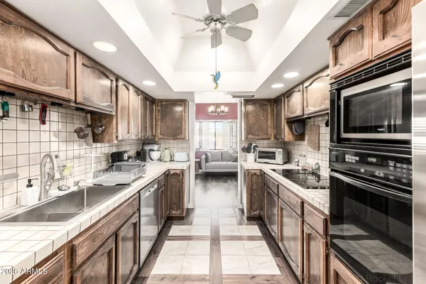 a kitchen with a sink stainless steel appliances and cabinets