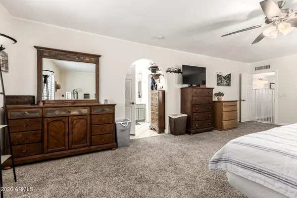 a living room with furniture and dresser