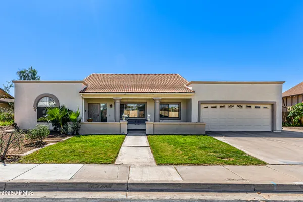 a front view of house with yard and green space